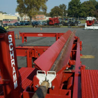 Close up of pipe on Schramm TXD LoadSafe compact trailer mounted automated pipe system outside of Schramm's US shop.