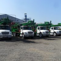Four EDM 33K series drill rigs on trucks