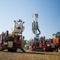 Two EDM 45K-D Series Drill Rigs outside.