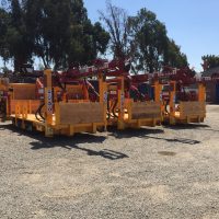 Three Exploration Drill Masters Rod Feeders side by side.
